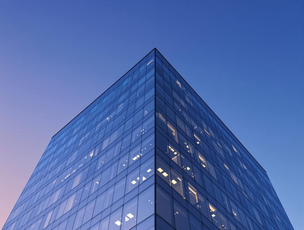 Corner of a modern glass office tower at dusk, representing a locally incorporated company in Argentina